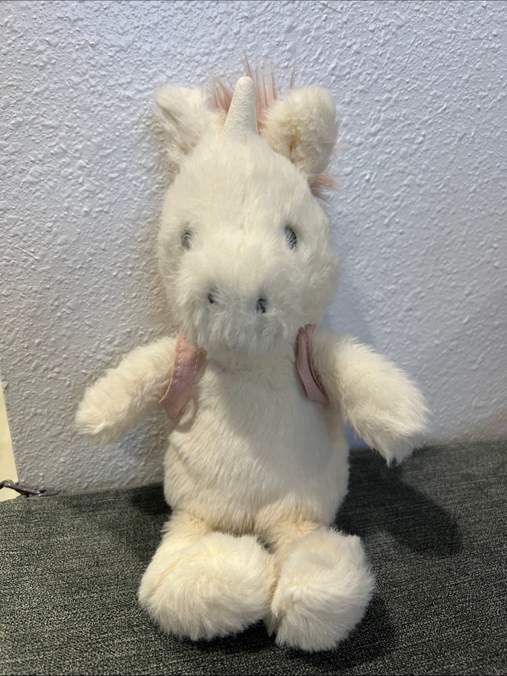 Jellycat Unicorn Stuffed Animal wearing backpack